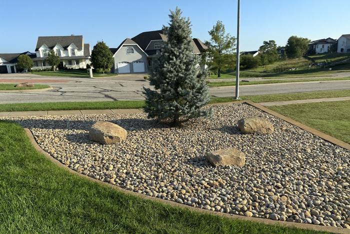 Rock island with boulders and a blue spruce