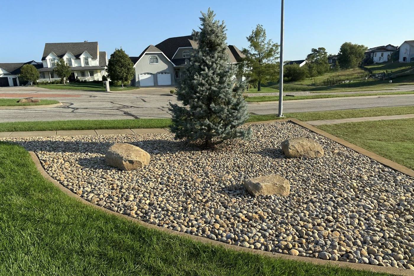 Rock island with boulders and a blue spruce